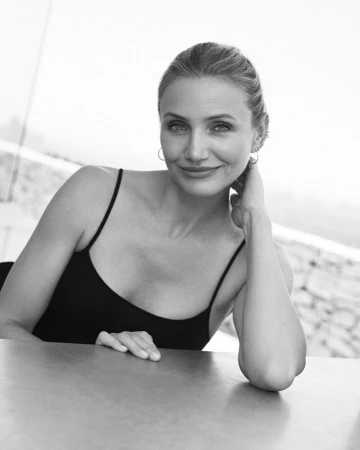 Portrait of Cameron Diaz in a black tank top with her hand raised to her neck, photographed by Camilla Armbrust.