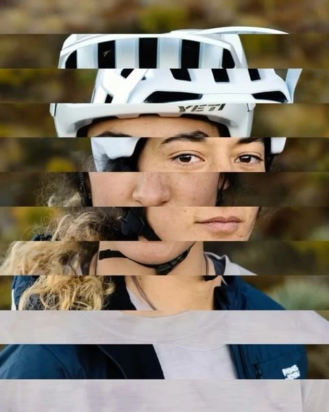 Close-up of a woman in a white helmet with a YETI logo. The shot is spliced with horizontal lines that cut through the face and helmet.