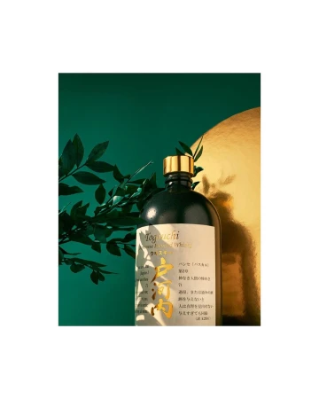 Togouchi Japanese blended whisky bottle with gold accents, set against green and gold background with botanical elements. 