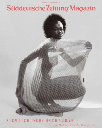 Magazine cover featuring an African American woman in a draped, mesh-like garment, against a neutral backdrop, with bold magazine text.