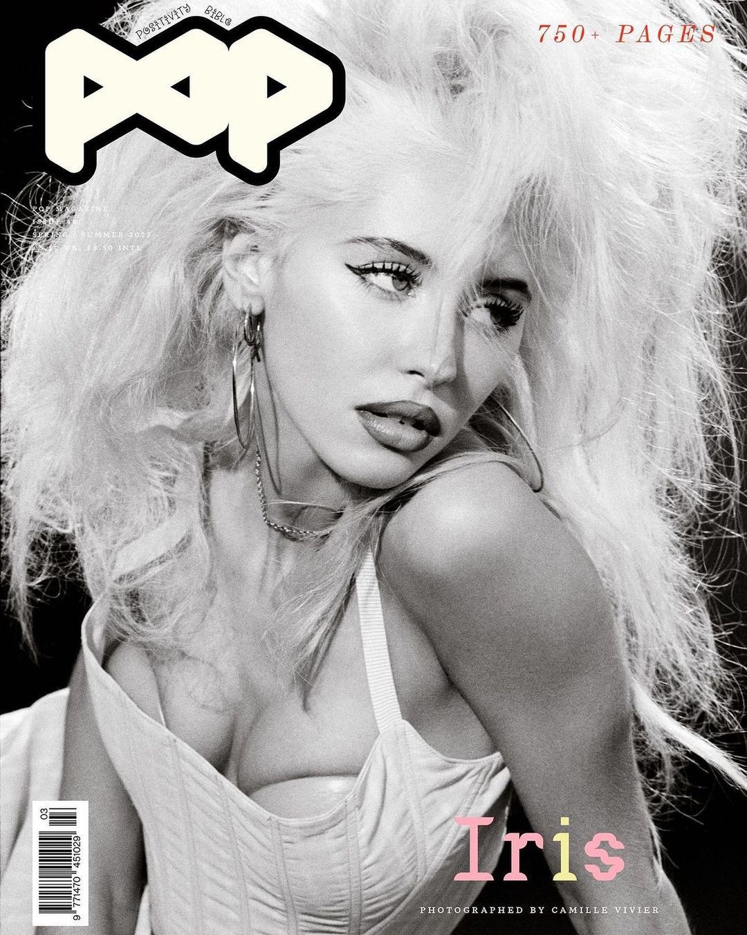 Monochrome magazine cover featuring a woman with voluminous blonde hair wearing hoop earrings and a light-coloured corset top.