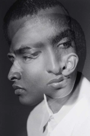 Monochromatic portrait of a Black man with a thoughtful expression created through a multiple exposure photography technique in a studio.
