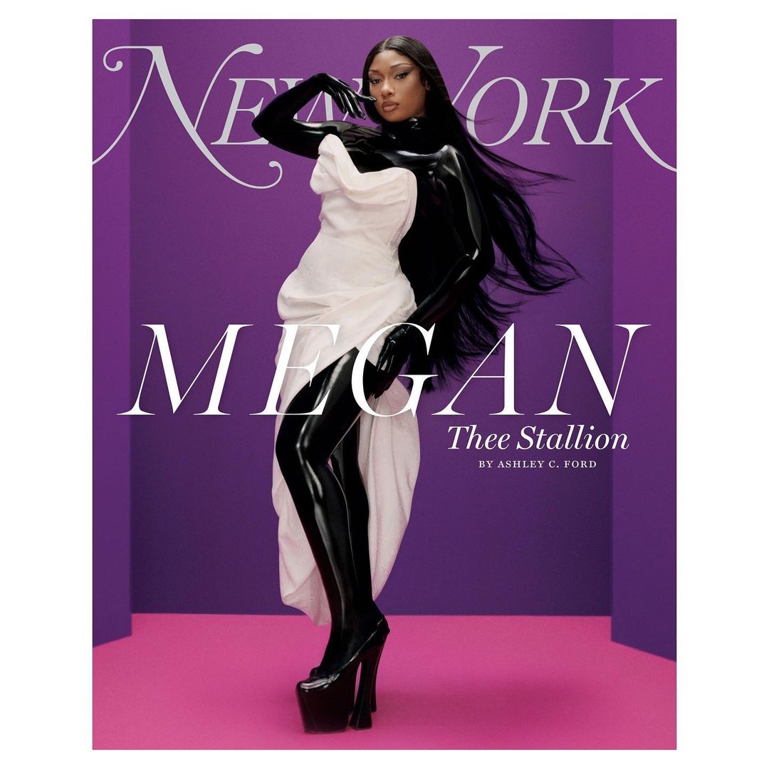 Megan Thee Stallion on New York magazine cover wearing a white dress and black gloves and boots, posing against a purple backdrop.