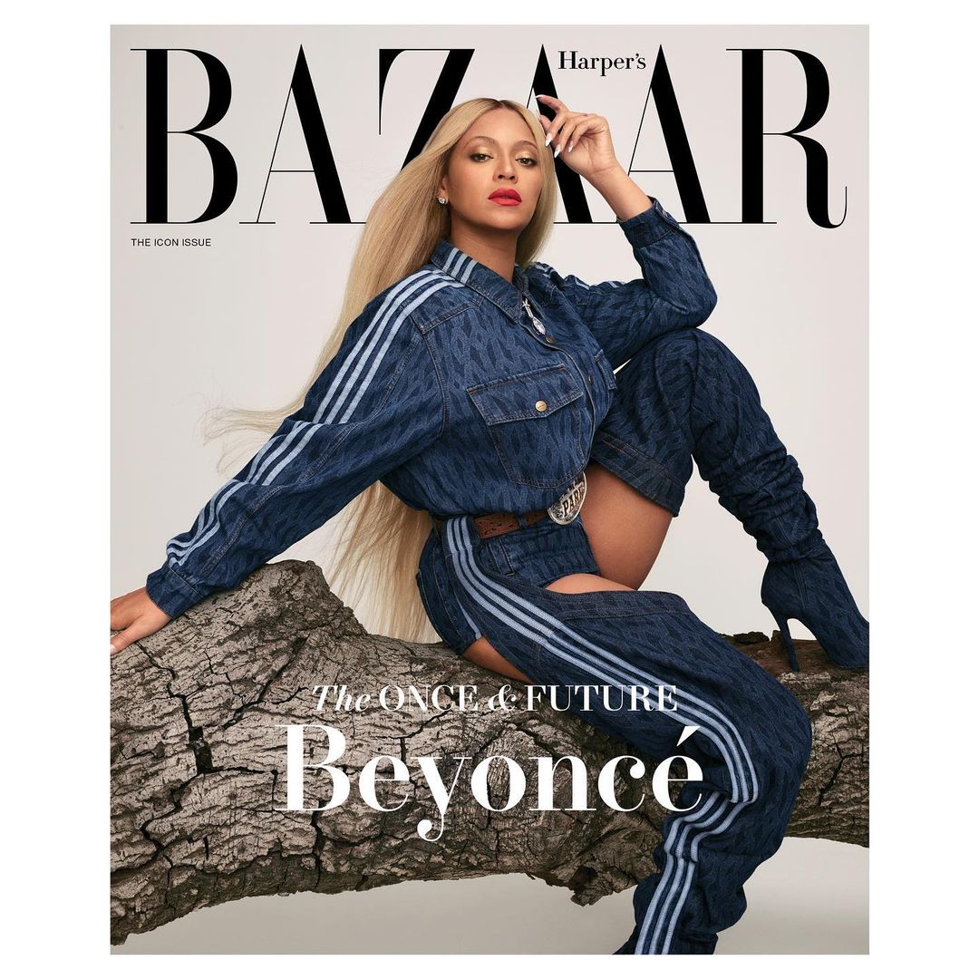 Harper's Bazaar cover featuring a model in a denim outfit, seated on a fallen tree, against a neutral backdrop. Fashion and editorial.
