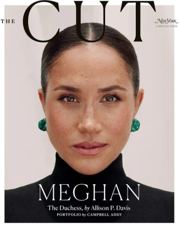 Magazine cover featuring a close-up portrait of Meghan Markle, who is wearing green earrings and a black turtleneck against a pale background.