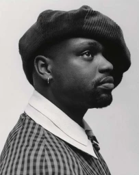 Portrait of a Black man in profile wearing a dark beret and patterned shirt shot by Campbell Addy in London.