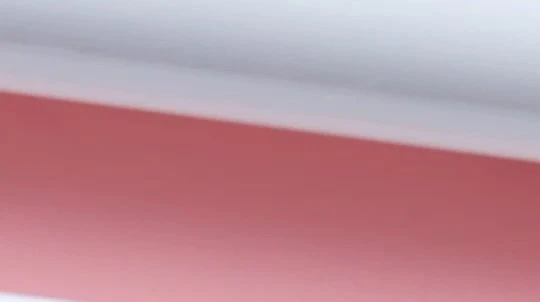 Abstract background of light pink and white colors with a diagonal gradient, creating a soft and simple design for various applications.