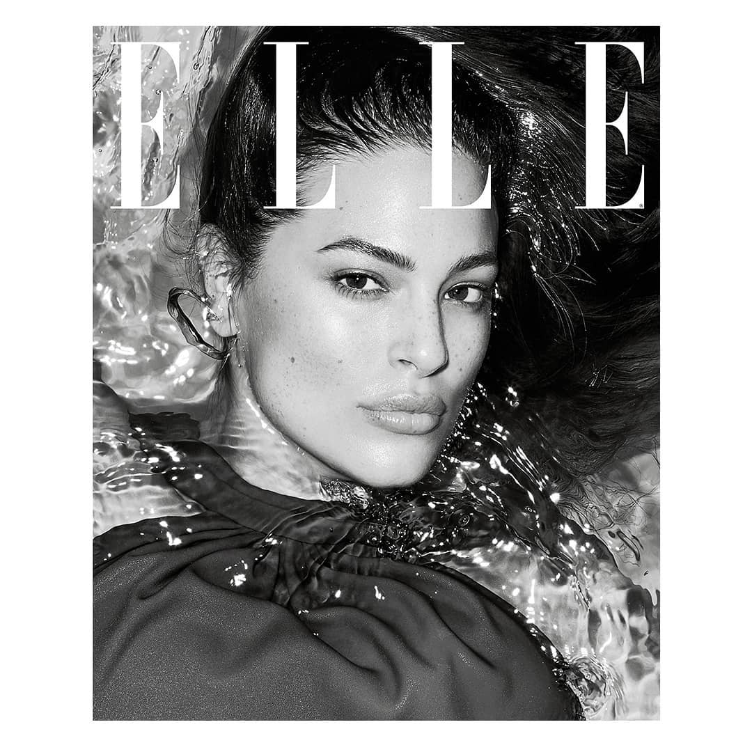 Black-and-white close-up of a model with wet hair and water around her face, as featured on the cover of Elle magazine.