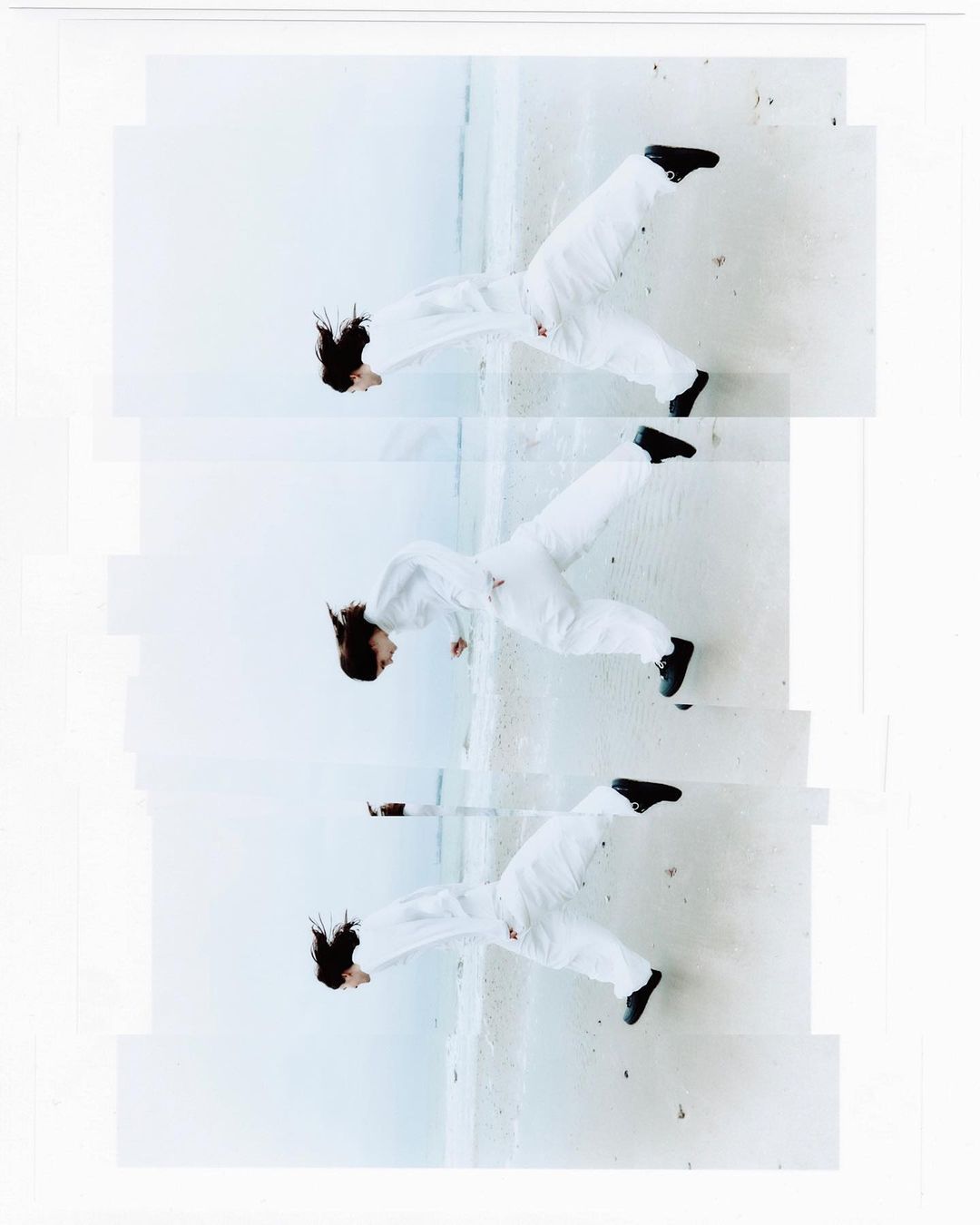 Three images of a woman wearing a white jumpsuit and black shoes, posed mid-air against a concrete surface, top angle, indoor.