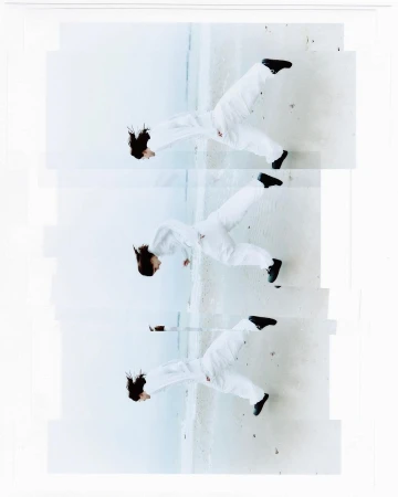 Three images of a woman wearing a white jumpsuit and black shoes, posed mid-air against a concrete surface, top angle, indoor.