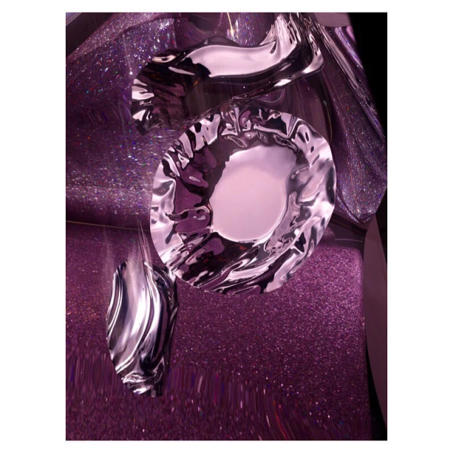 Abstract still life features shiny, metallic, irregularly-shaped decorative objects with a liquid appearance against a glittery purple background.