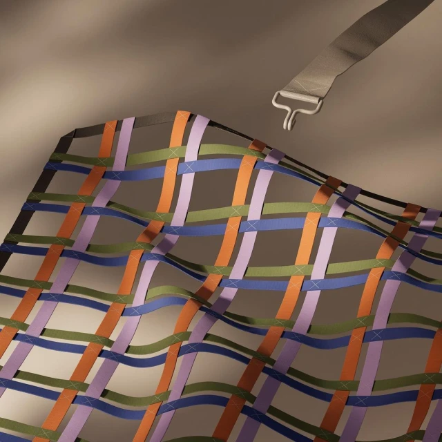 Woven pattern of orange, green, blue, and purple ribbons creating a net or grid, attached with a webbing strap and metal buckle.