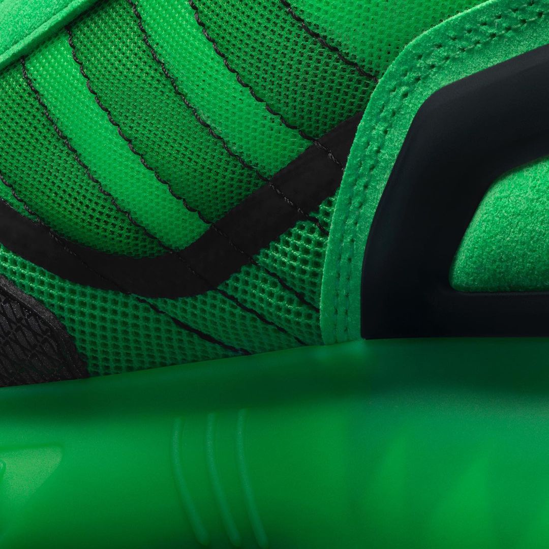 Close-up on a green and black athletic shoe featuring a breathable mesh upper, structured overlays, and a responsive sole for sports.