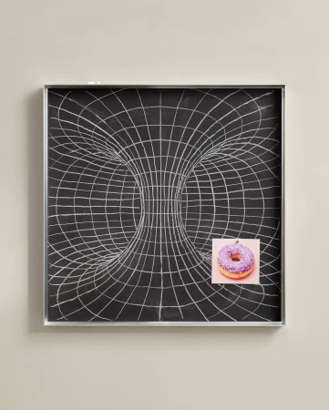 Abstract illustration of a black chalkboard with a wormhole graphic and a donut on pink paper attached, conveying a mix of science and snack.