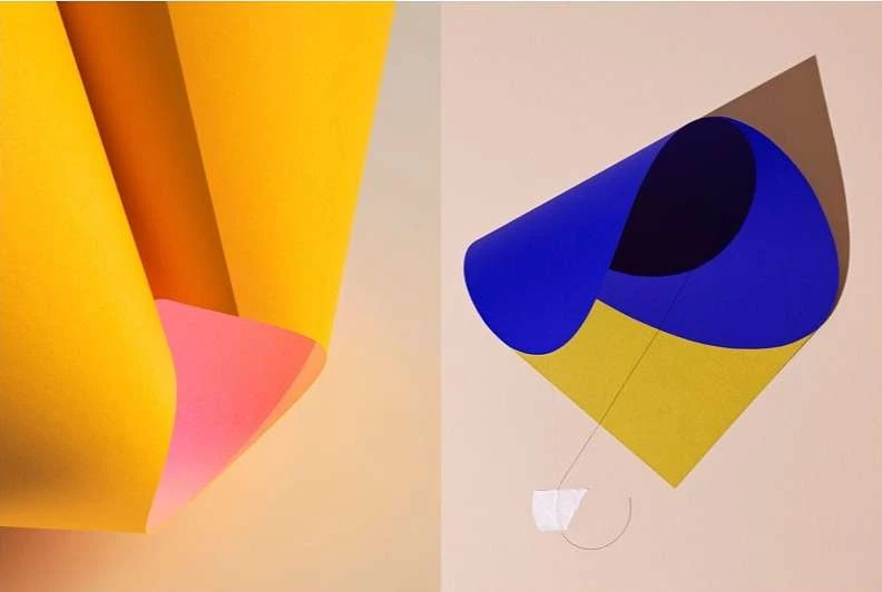 Abstract split-screen image featuring yellow and pink folded paper on the left and a blue and yellow paper sculpture on the right.