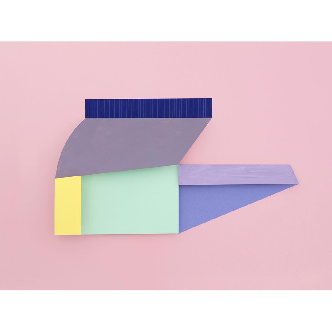 Abstract geometric shapes in pastel colors: blue, purple, yellow and green, against a solid pink background in a minimalist design.