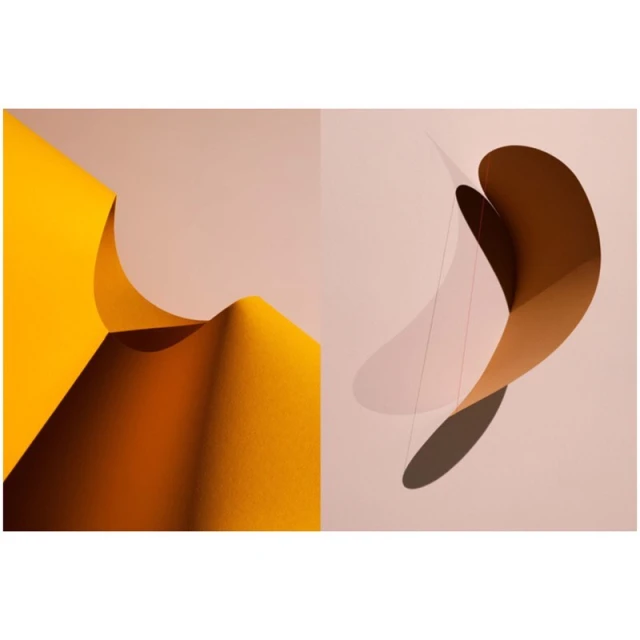 Abstract studio shot of curved, colorful papers with smooth gradients. The left side is yellow, and the right features brown and pink.