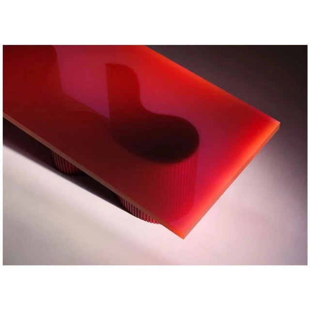 Abstract close-up of a red rectangular table with rounded corners, supported by multiple cylindrical legs, set against a gray gradient background.