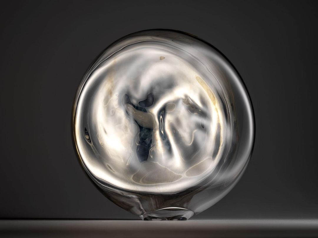 Abstract transparent glass vase with an organic shape reflects diffused light, creating a serene, modern aesthetic on a neutral backdrop.