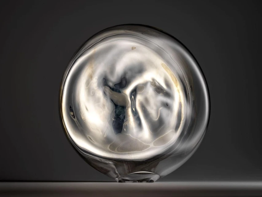 Abstract transparent glass vase with an organic shape reflects diffused light, creating a serene, modern aesthetic on a neutral backdrop.