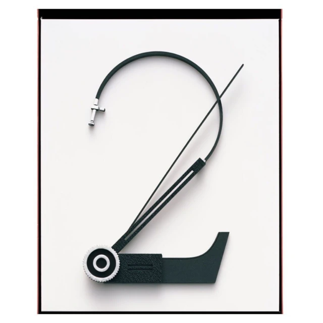 Abstract clock hand art. The clock hand is bent to make the shape of a number two set against a bright white background. 