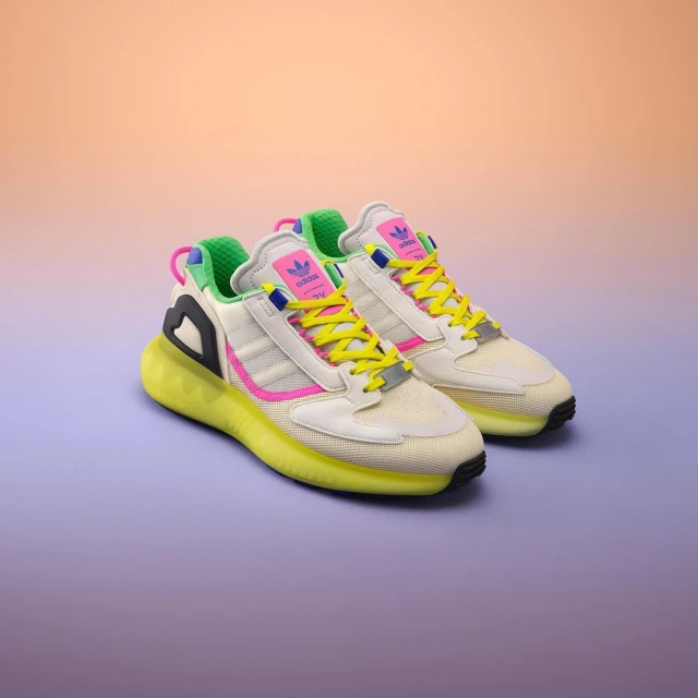 Pair of Adidas ZX 2K Boost 2.0 shoes displayed on a gradient peach and purple background in a studio setting, colorful design.