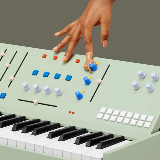 Close-up of an adult hand adjusting the knobs on a green synthesizer with black and white keys on a solid background.