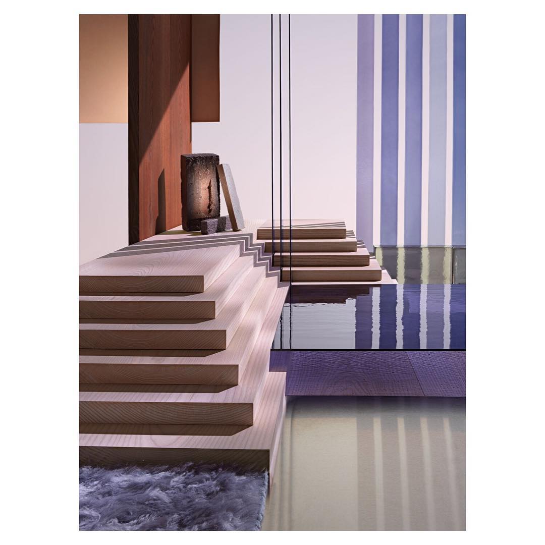 Architectural staircase design with neutral wood steps, textured rug, glass panels, and striped wall pattern in soft lighting.