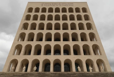 Low angle view of the imposing symmetrical facade of the Palazzo della Civilta Italiana in Rome under an overcast sky.