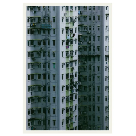 Dense urban apartment blocks tower with rows of windows and air conditioning units, emphasizing the high-density architecture of city living.