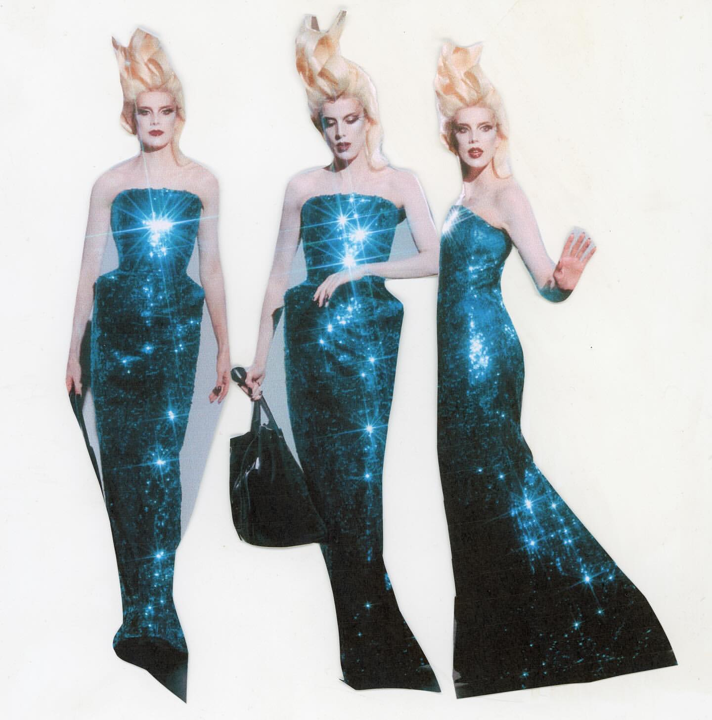 Three fashion models in sparkly dresses and elaborate hair, standing in front of a white backdrop, two with hand accessories. 