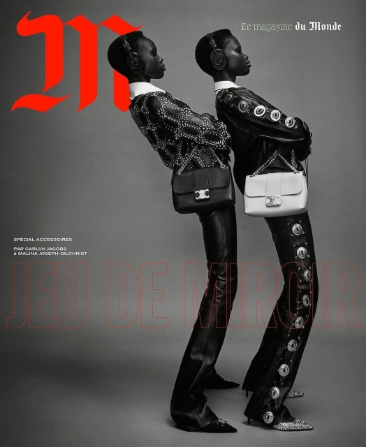 Two women in leather outfits and headsets pose against a gray background, each carrying a purse. Fashion editorial style.