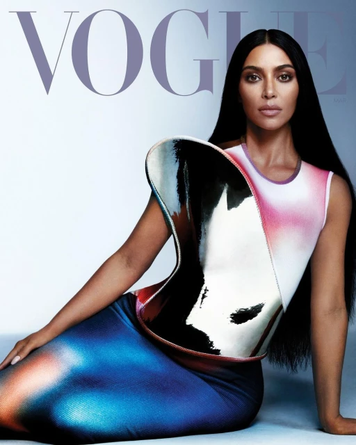 Celebrity Kim Kardashian poses in a futuristic dress on the cover of Vogue, showcasing beauty and high fashion in a studio setting.