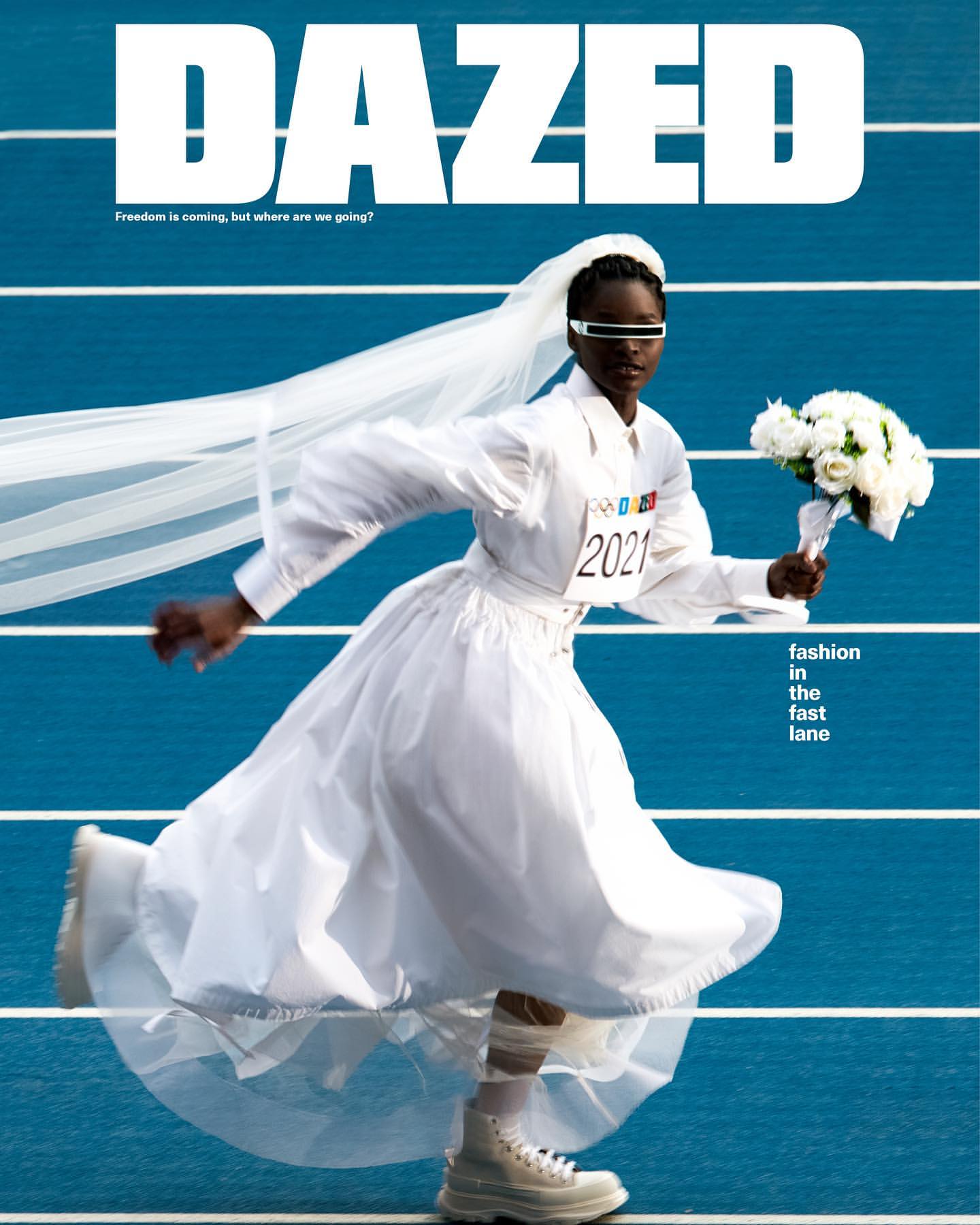 Magazine cover featuring a Black female model in white wedding dress and sneakers, running on a blue track with white flowers.