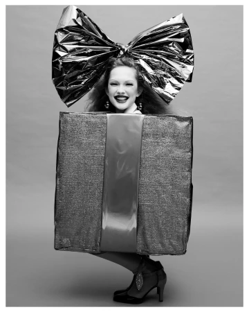 Model wearing a large metallic gift box costume with a matching giant bow by Carlijn Jacobs in Paris