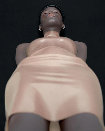 Low angle editorial portrait of a Black woman wearing a glossy nude dress against a black background shot by Carlijn Jacobs