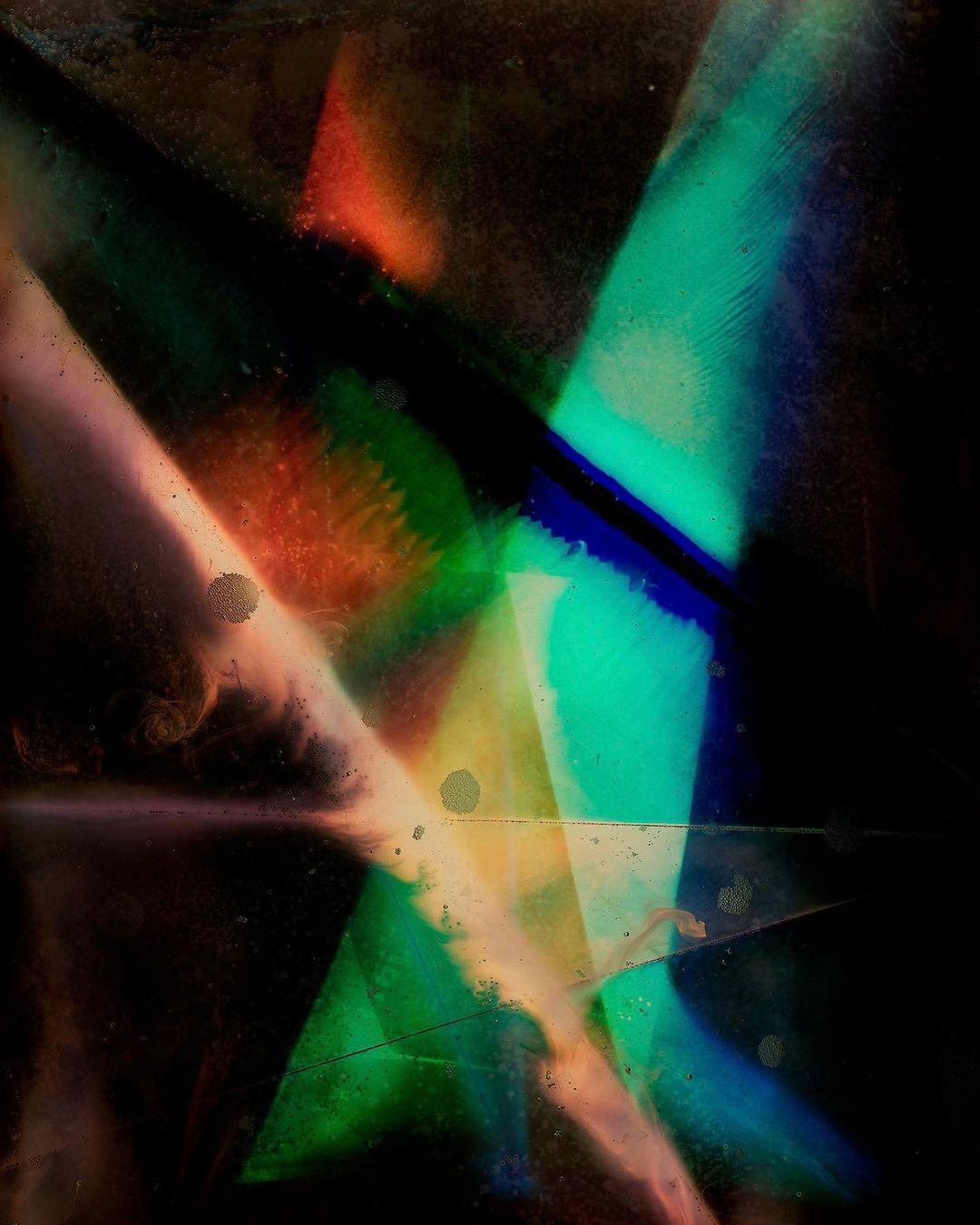 Abstract art featuring intersecting geometric shapes in teal, orange, blue, and black, with a dark background and textured surface.