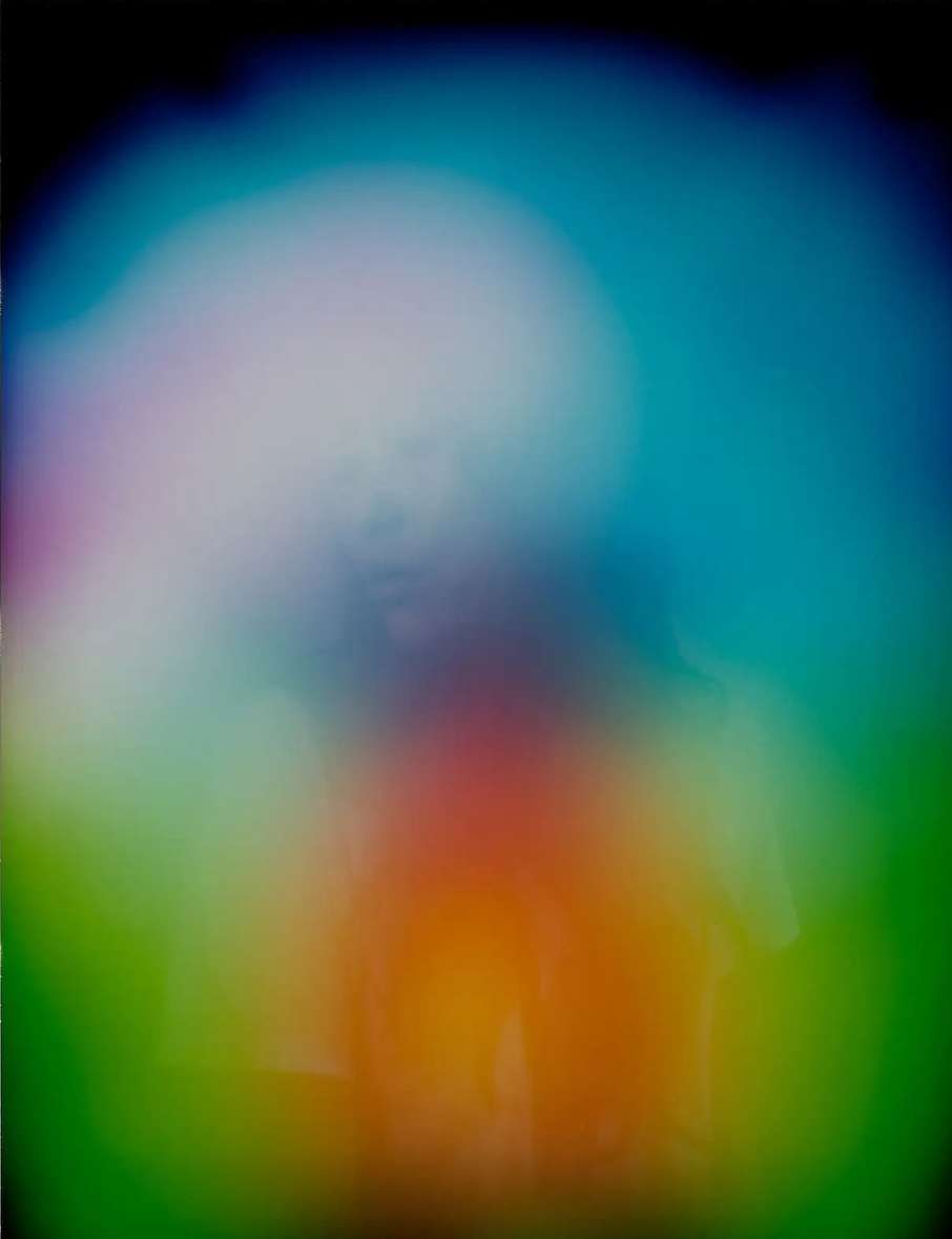 Abstract gradient background with a blend of blue, white, green, red, and orange hues creating a smooth, blurred, and vibrant effect.
