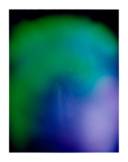 Abstract digital artwork with a blurred gradient of green, blue, and purple hues, set against a dark background for visual contrast.