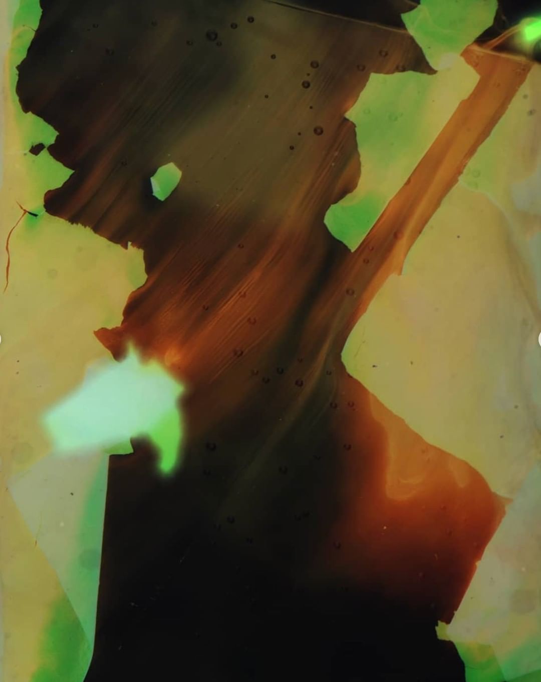Abstract art featuring flowing black and brown shapes with hints of green, creating a mysterious and visually engaging composition.