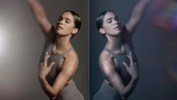 Portrait of a woman in a gray bodysuit strikes a dance pose, showcasing grace and strength against soft gray and dark backgrounds.