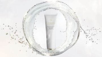Cosmetic tube surrounded by a splash of water on a white background, product shot for beauty or skincare advertising.
