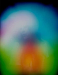An abstract photographic portrait by Carlo Van De Roer featuring vibrant fields of blue, green, and orange light.