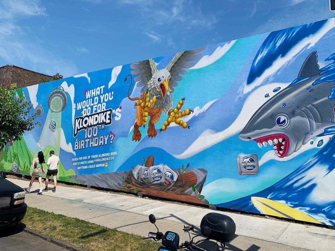 Outdoor mural art on a building featuring a griffin, shark, and Klondike ice cream bar for Klondike's 100th Birthday campaign.
