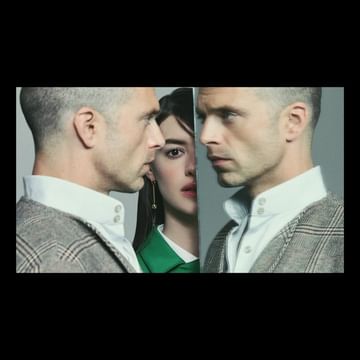 Three people pose in front of a grey background, with two men facing away from each other and a woman's face in the middle.
