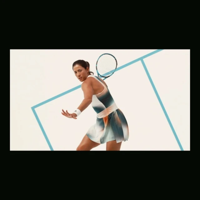 Female tennis player in motion, swinging racket on light background with blue geometric lines. Action shot, sport and athletic theme.