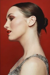 Profile portrait of a woman with red lips and a sequined dress against a solid red background