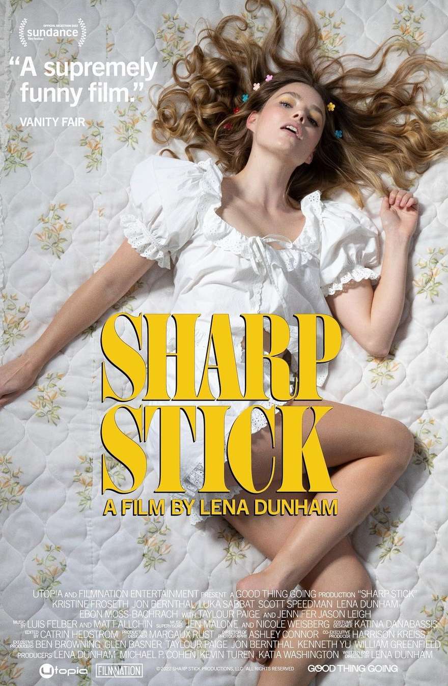 Movie poster for Sharp Stick featuring a woman lying on a bed with a floral-patterned quilt, looking up at the camera with a smirk.