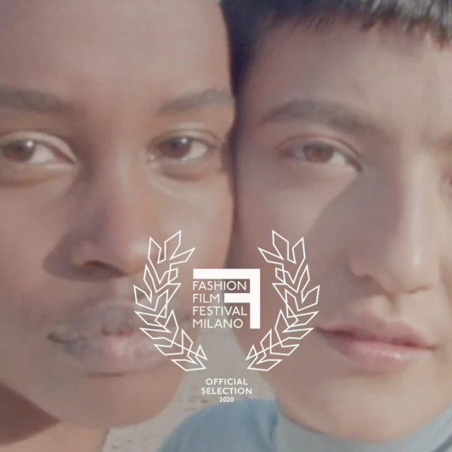 Close-up of two fashion models in a sunlit, outdoor setting, adorned with the Fashion Film Festival Milano logo and 'Official Selection 2020' text.