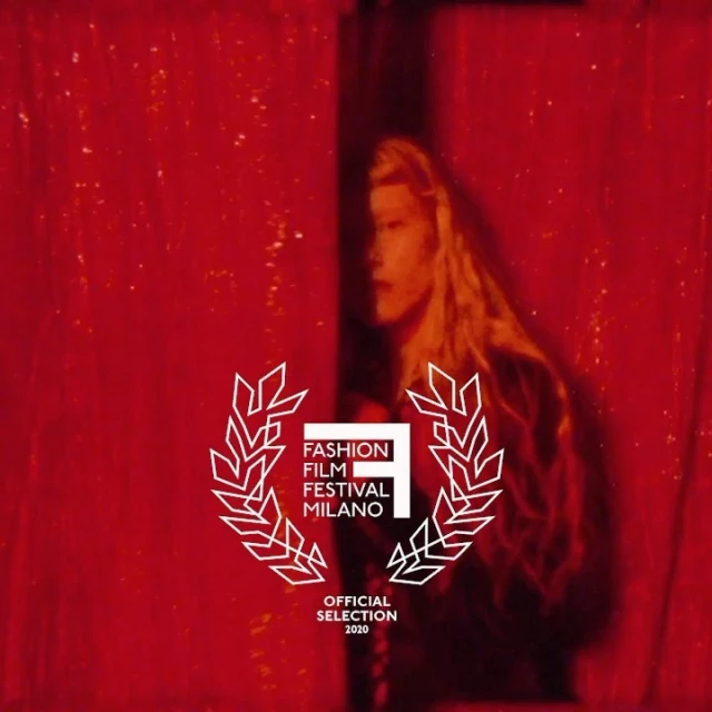 Fashion film festival Milano image features a woman with long blonde hair standing in front of a red curtain and a festival logo.